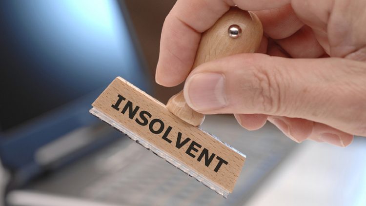 rubber stamp with inscription INSOLVENT