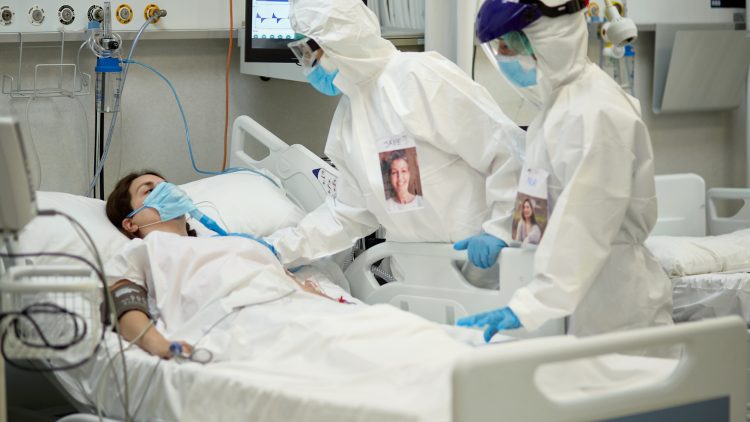 Female Doctor in Protective Suit Checking COVID-19 Patient