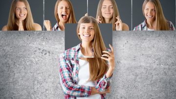 Young,European,Businesswoman,Hiding,Herself,Behind,Poster,With,Smiling,Face.
