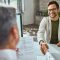 Young happy man shaking hands with a businessman on a job interv